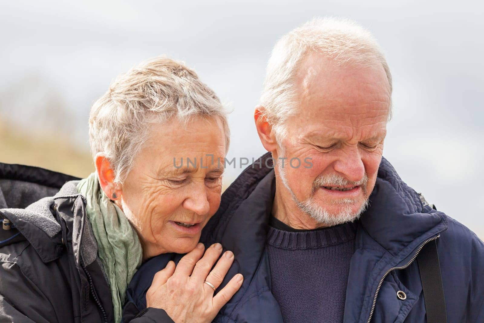 older adult happy couple walks on the beach in autumn lifestyle happiness