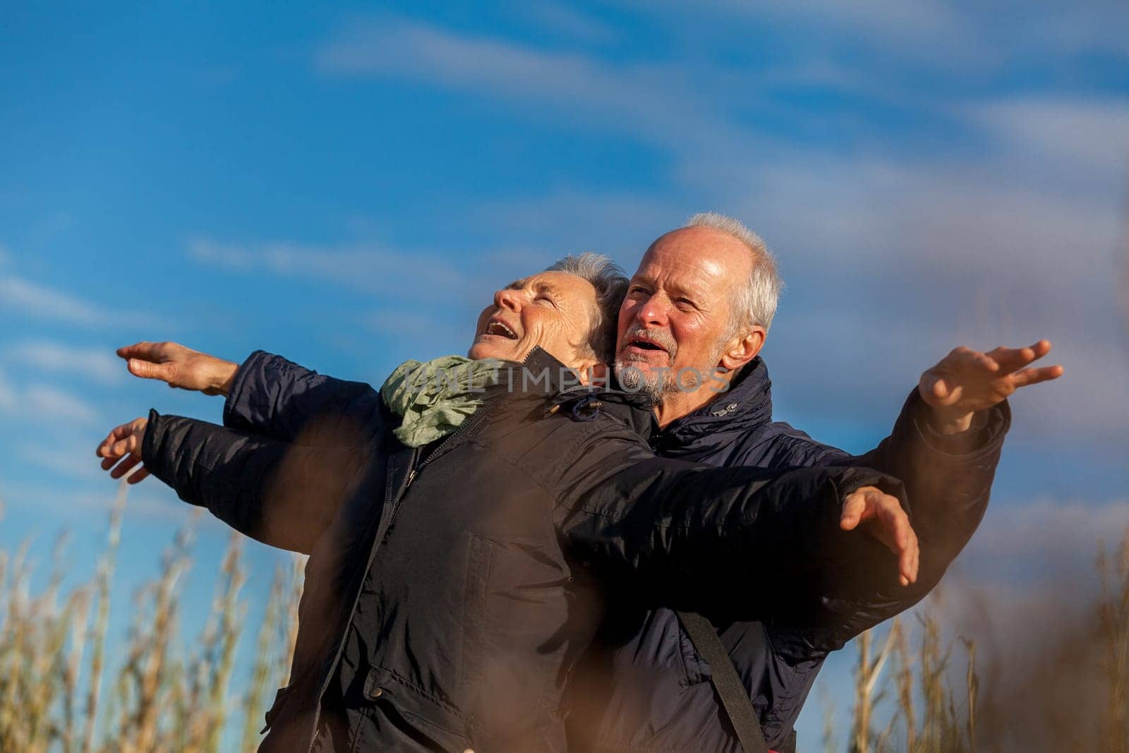 older seniors couple happy laughing in holiday leisure natural ostsee