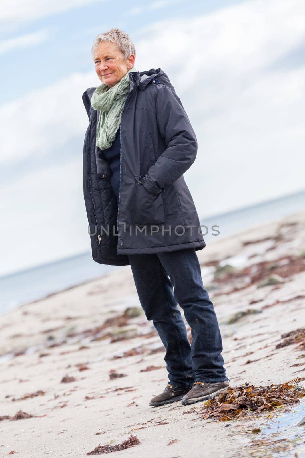 older adult happy couple walks on the beach in autumn lifestyle happiness