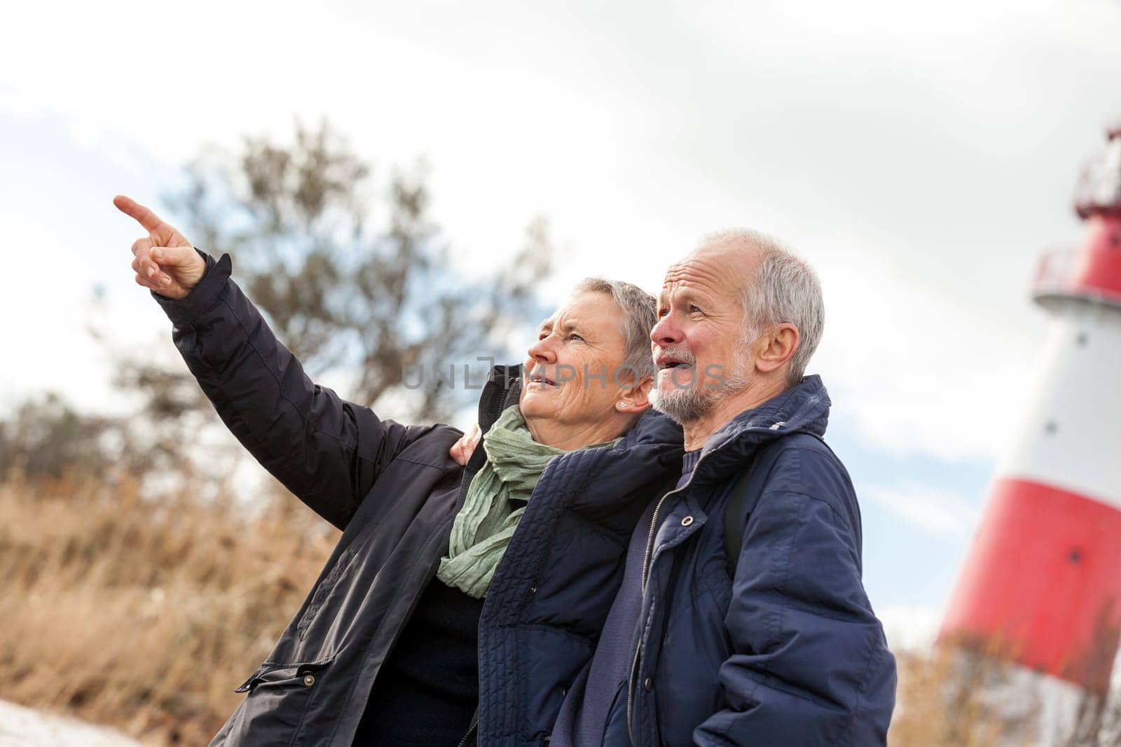 older happy couple makes a beach walk in autumn baltic sea landscape sea