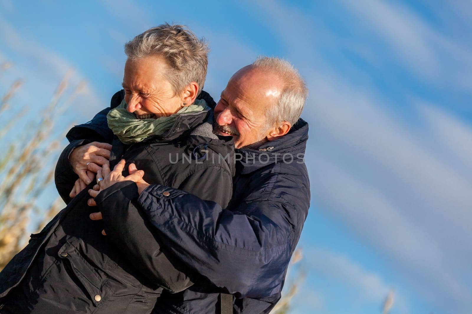 older seniors couple happy laughing in holiday leisure natural ostsee