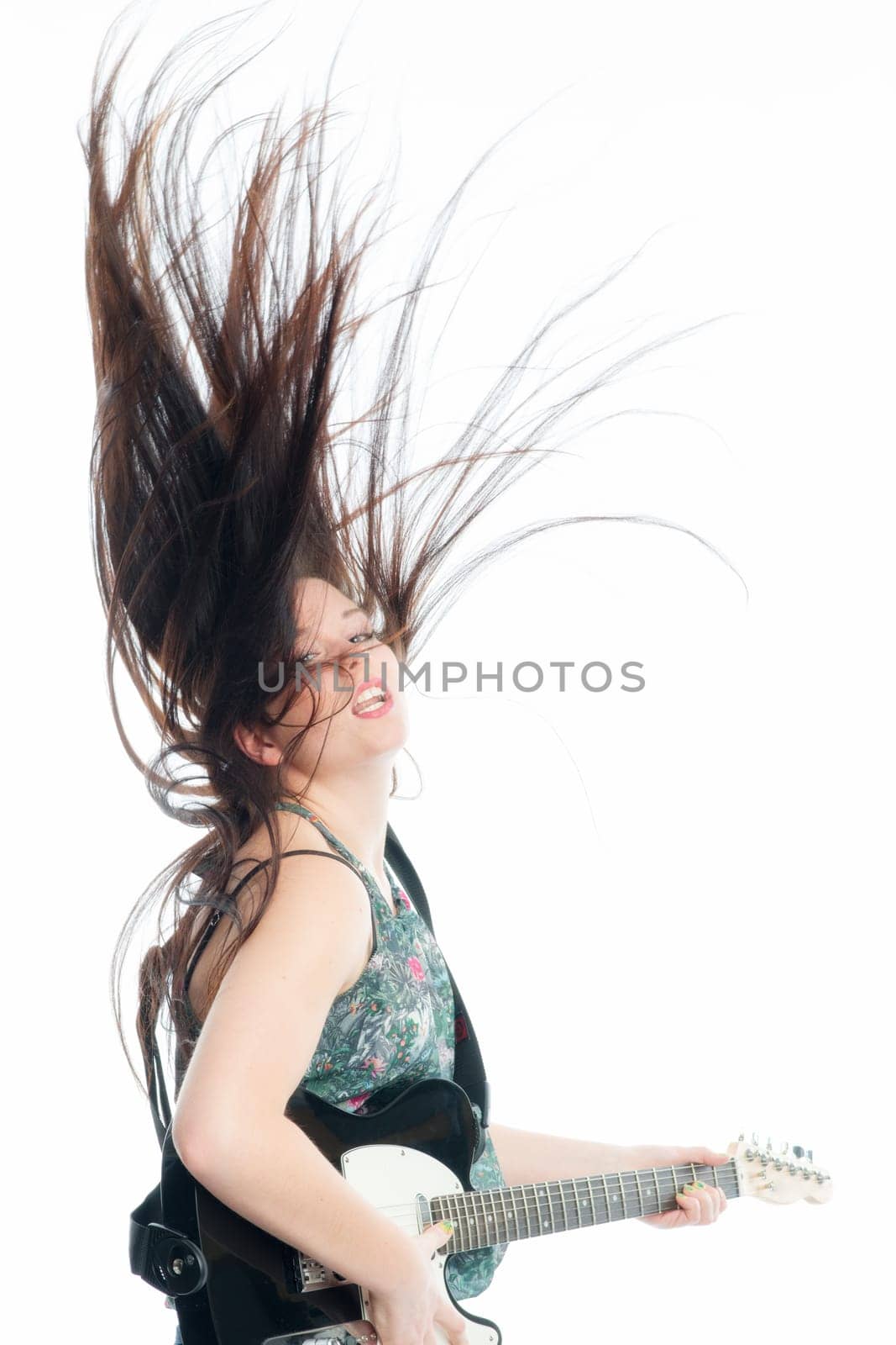 Young woman plays electric guitar
