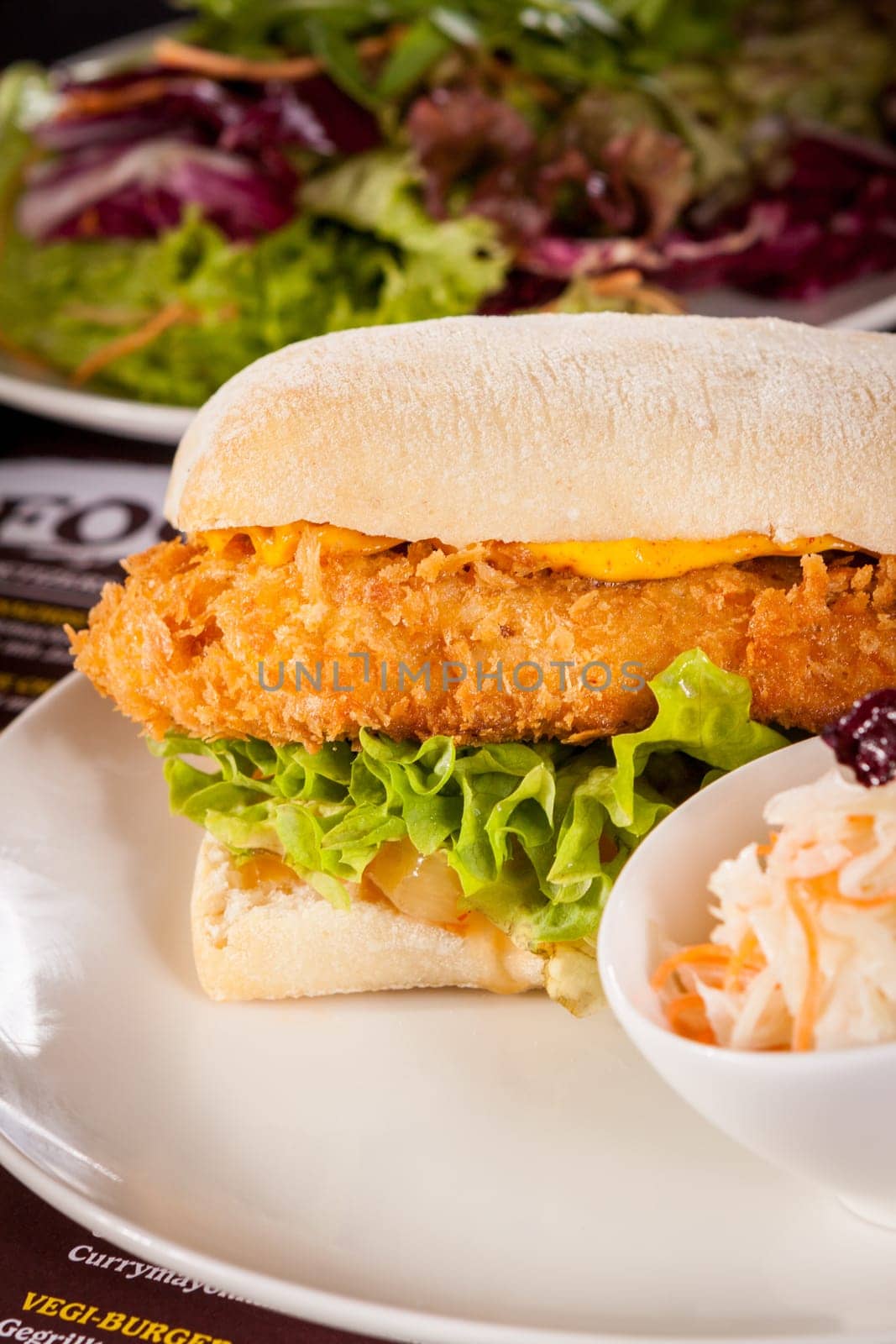 Chickenburger with chicken meat and salad as a close-up on a plate