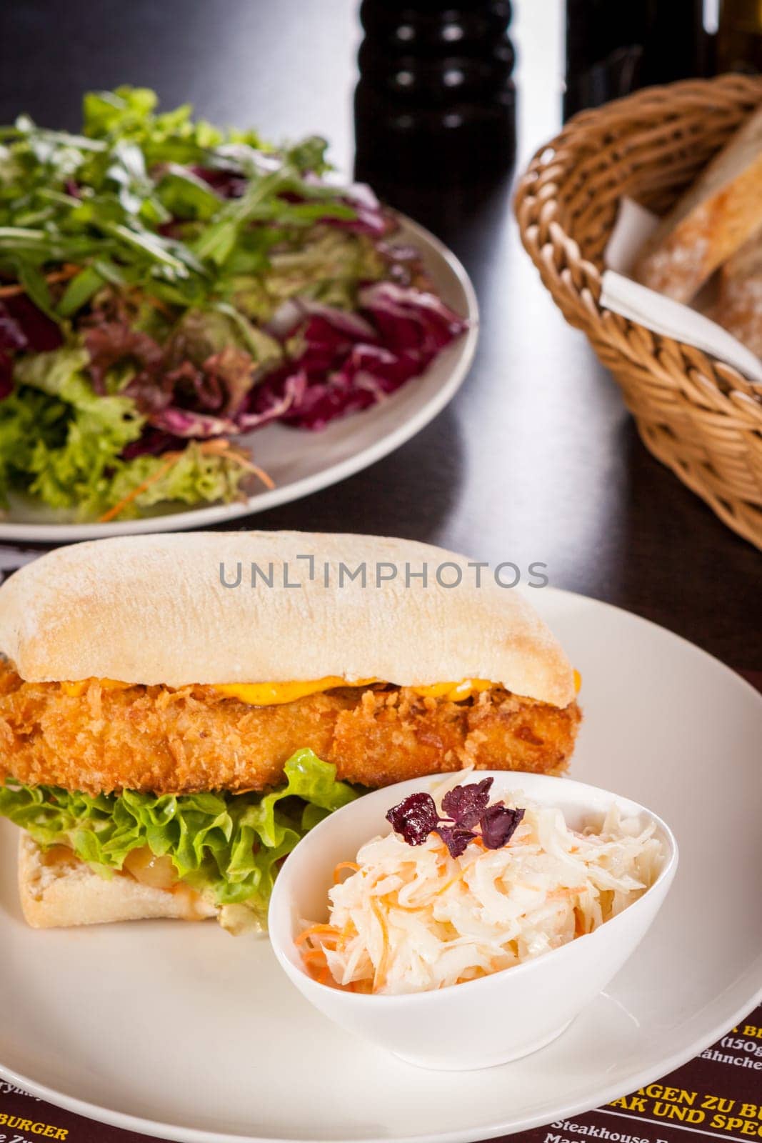 Chickenburger with chicken meat and salad as a close-up on a plate