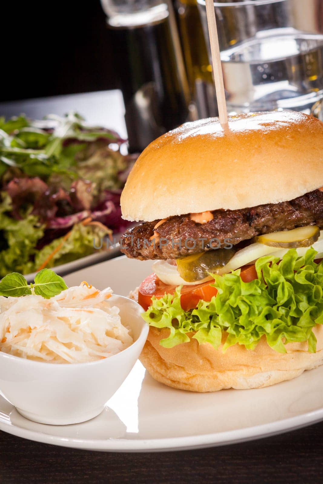 Delicious hamburger cheeseburger with bacon egg and salad on a plate
