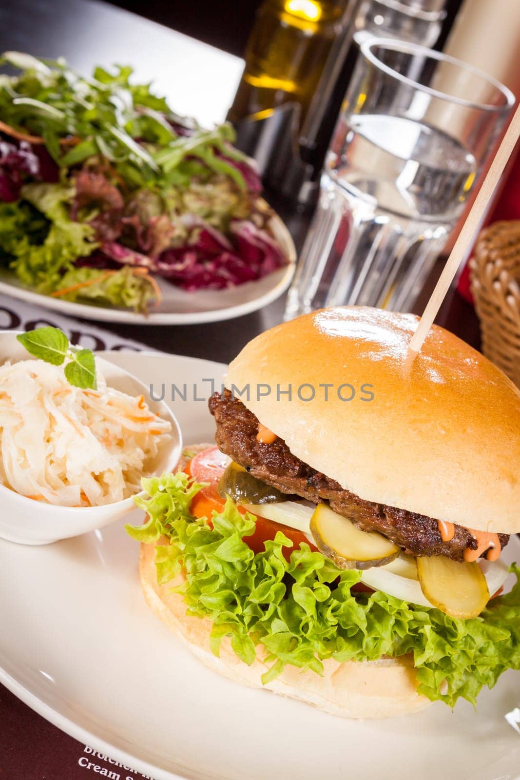 Delicious hamburger cheeseburger with bacon egg and salad on a plate
