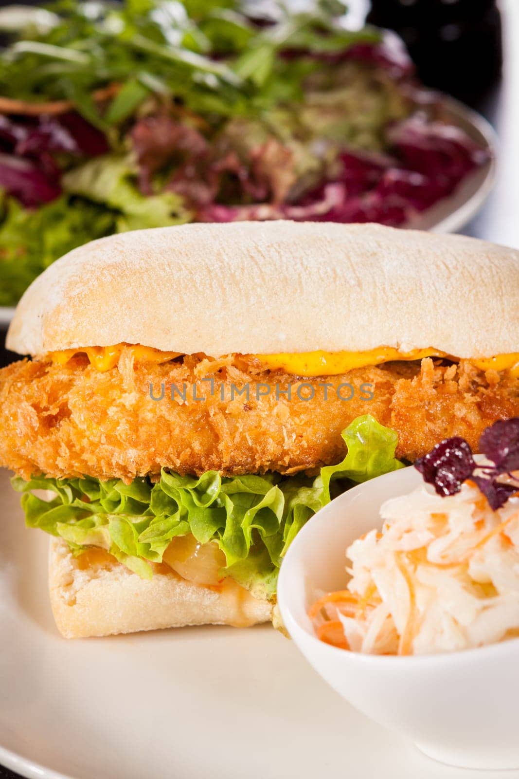 Chickenburger with chicken meat and salad as a close-up on a plate