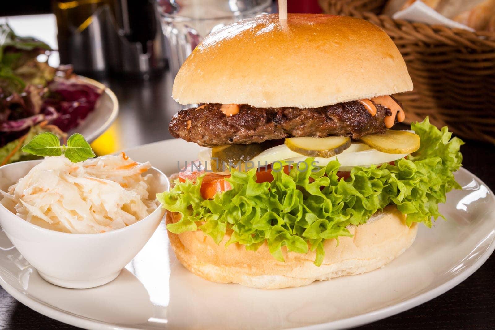 Delicious hamburger cheeseburger with bacon egg and salad on a plate