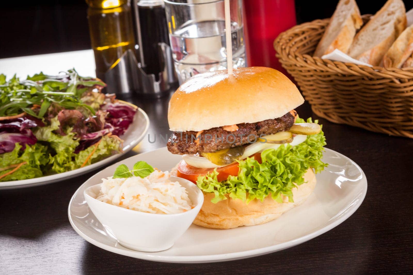 Delicious hamburger cheeseburger with bacon egg and salad on a plate