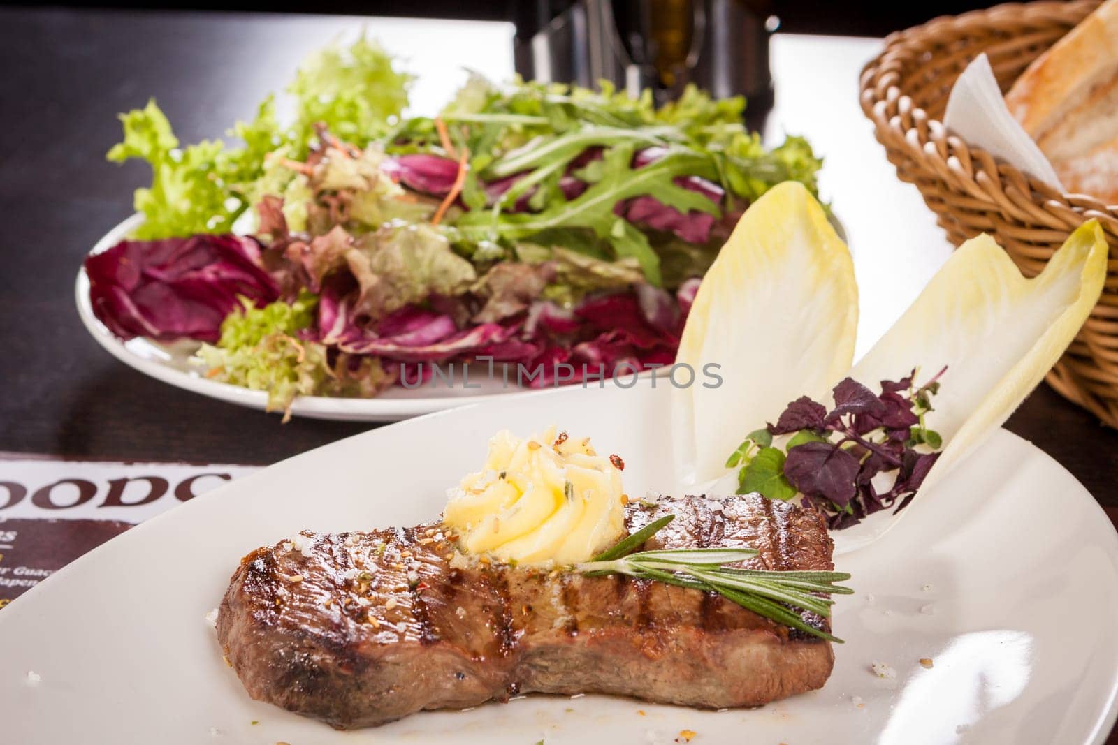 Succulent grilled beef fillet steak with homemade herb butter on a plate