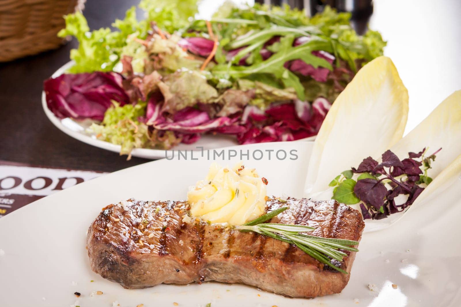 Succulent grilled beef fillet steak with homemade herb butter on a plate