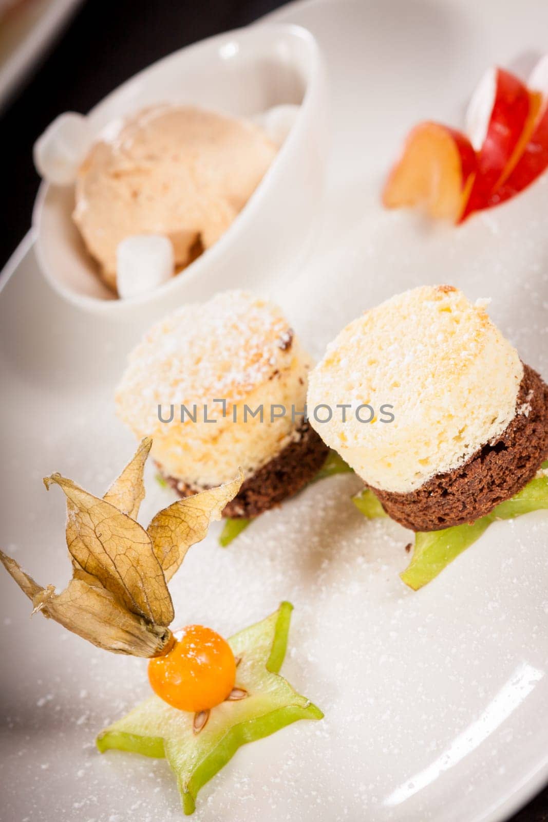 Brownie chocolate brownie with ice cream and plums prepared on a plate