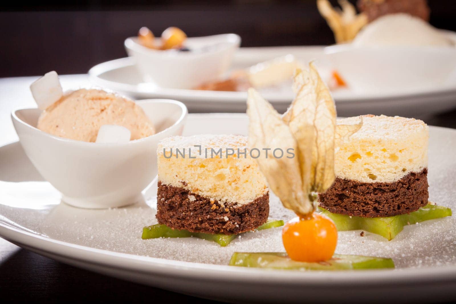 Brownie chocolate brownie with ice cream and plums prepared on a plate