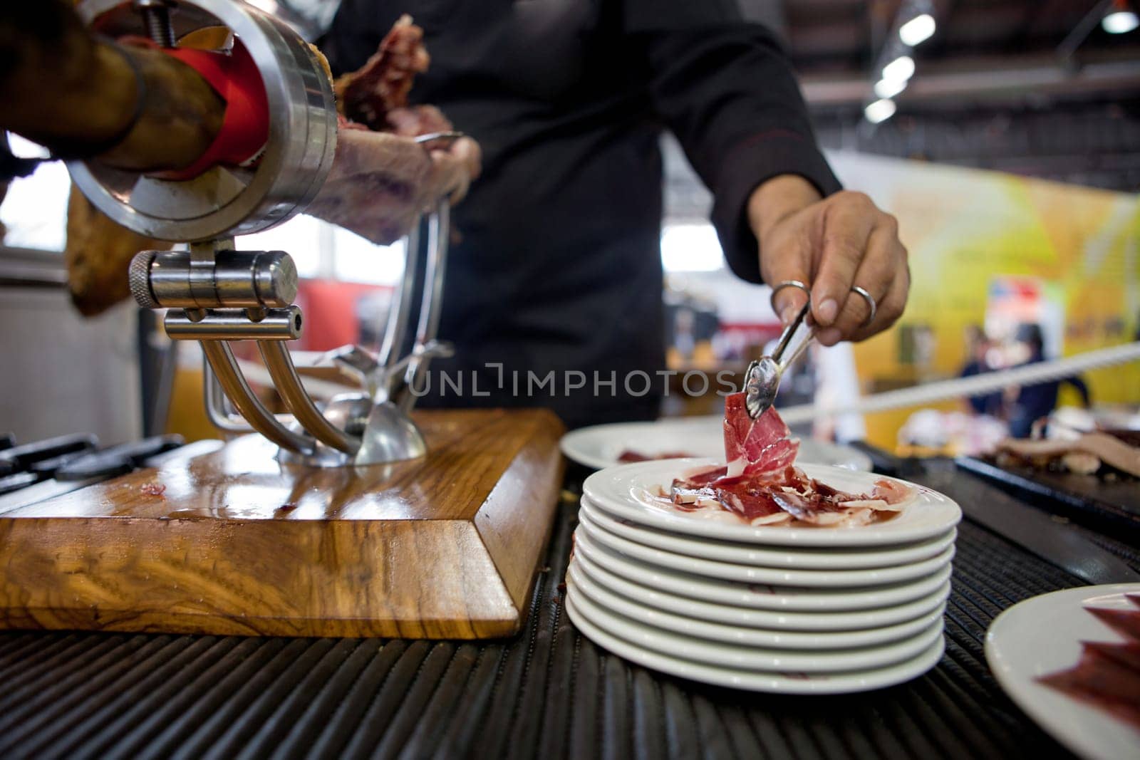 Waiter serving acorn-fed Iberian ham, Spain