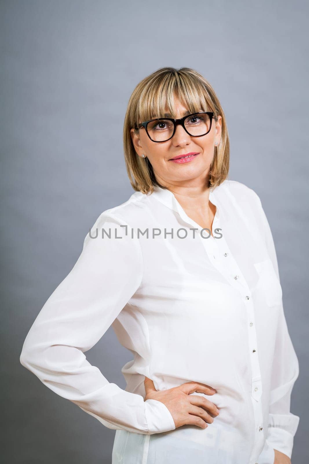 attractive adult woman in middle age with white blouse and brille
