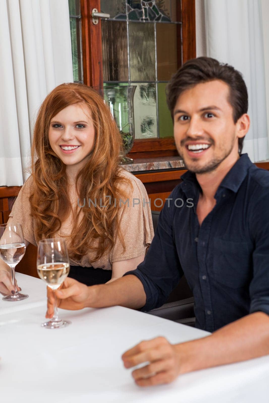 Young couple group in a restaurant cheerful while drinking