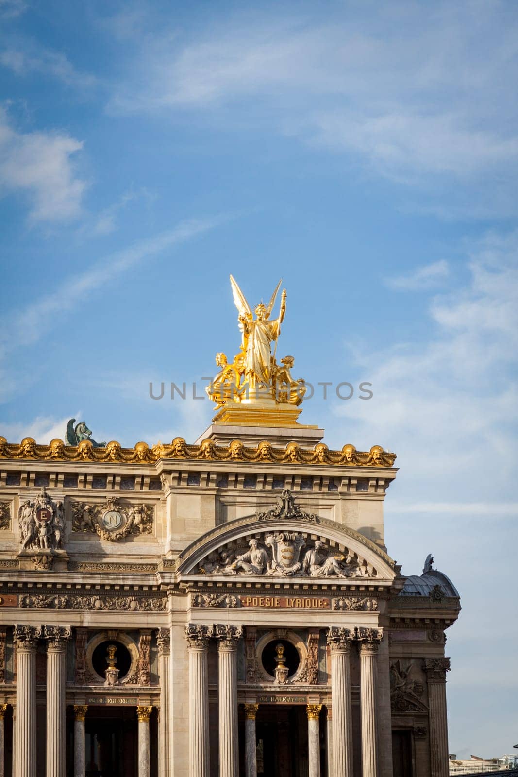 Exterior view of a Parisian townhouse in summer in front of a blue sky