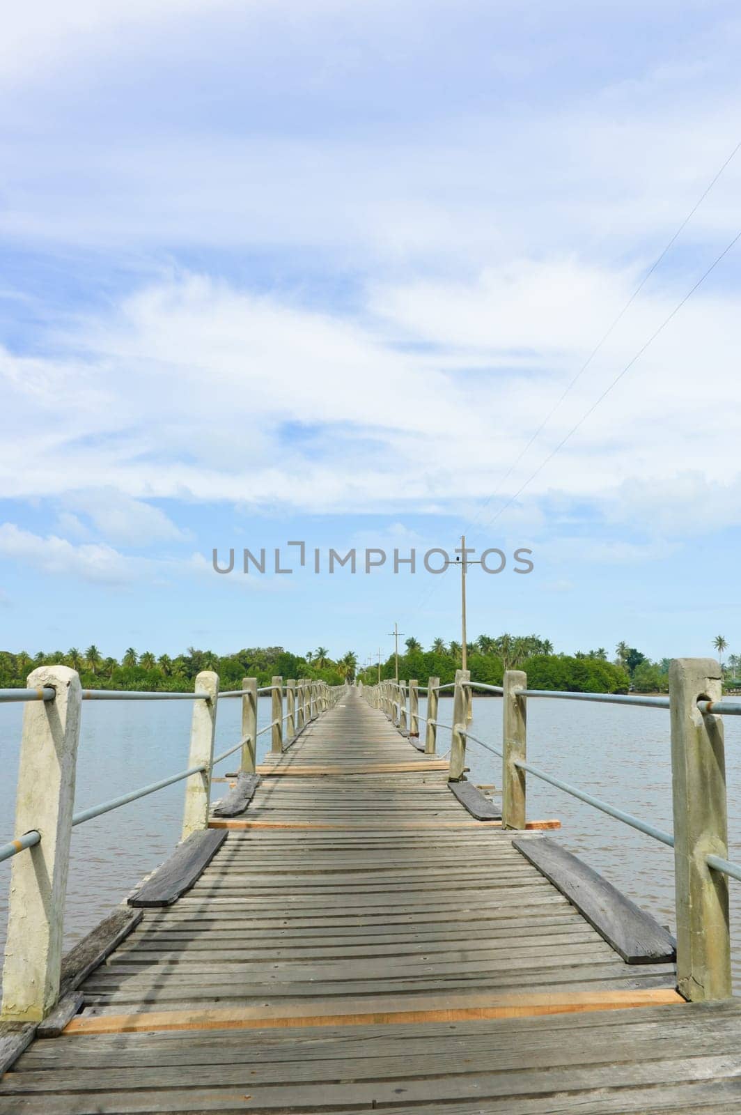 Long wood bridge over a river in low angle view