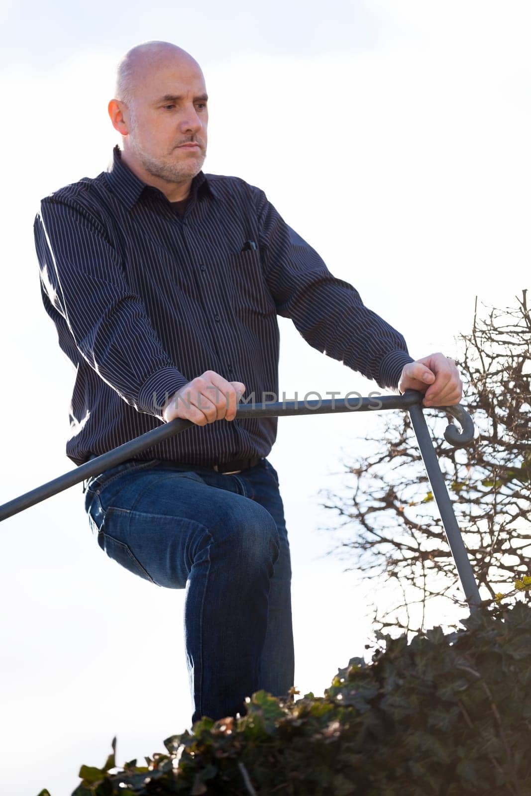 Man middle-aged senior pensioner taking a break in the outdoor park