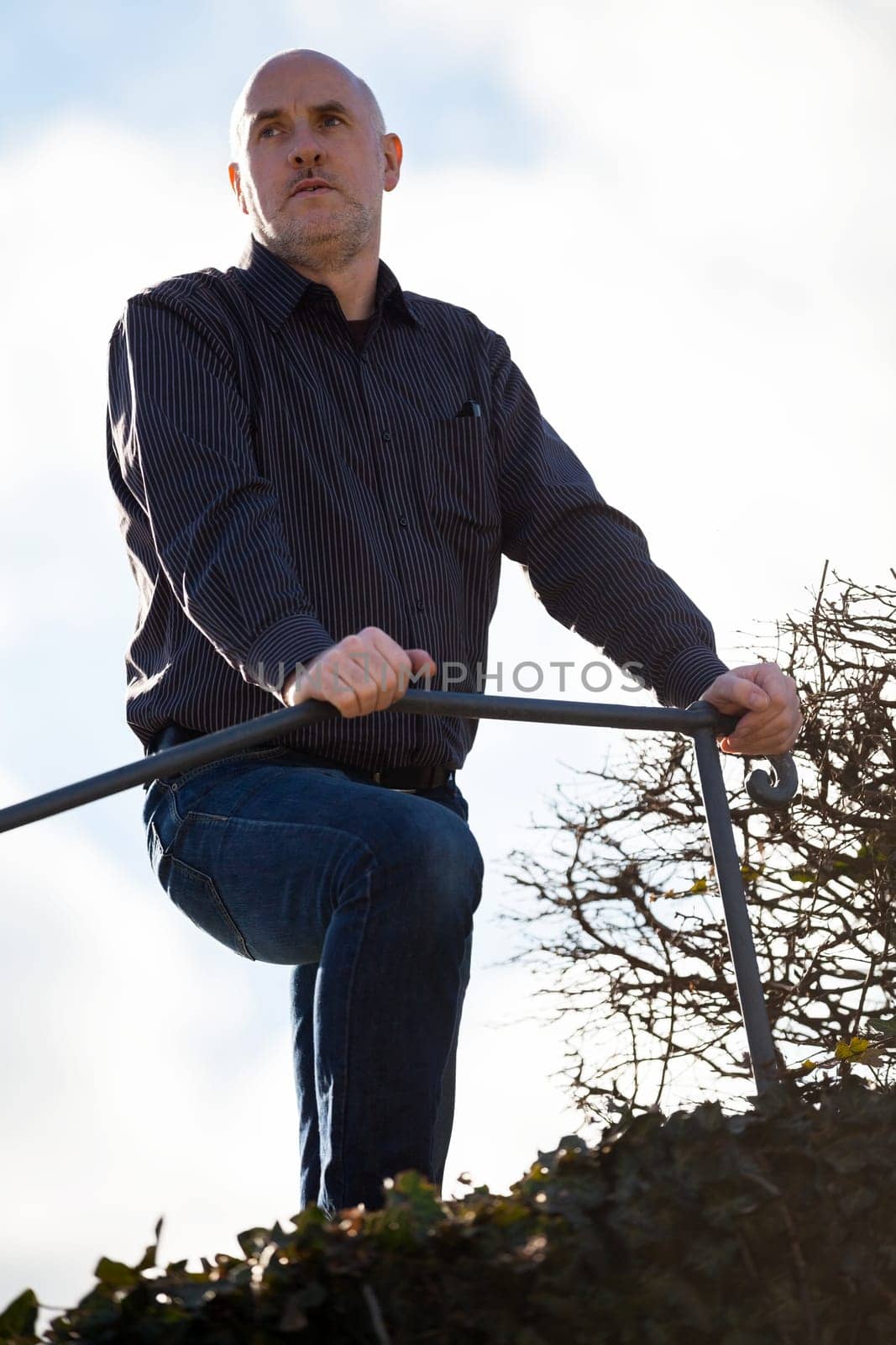 Man middle-aged senior pensioner taking a break in the outdoor park