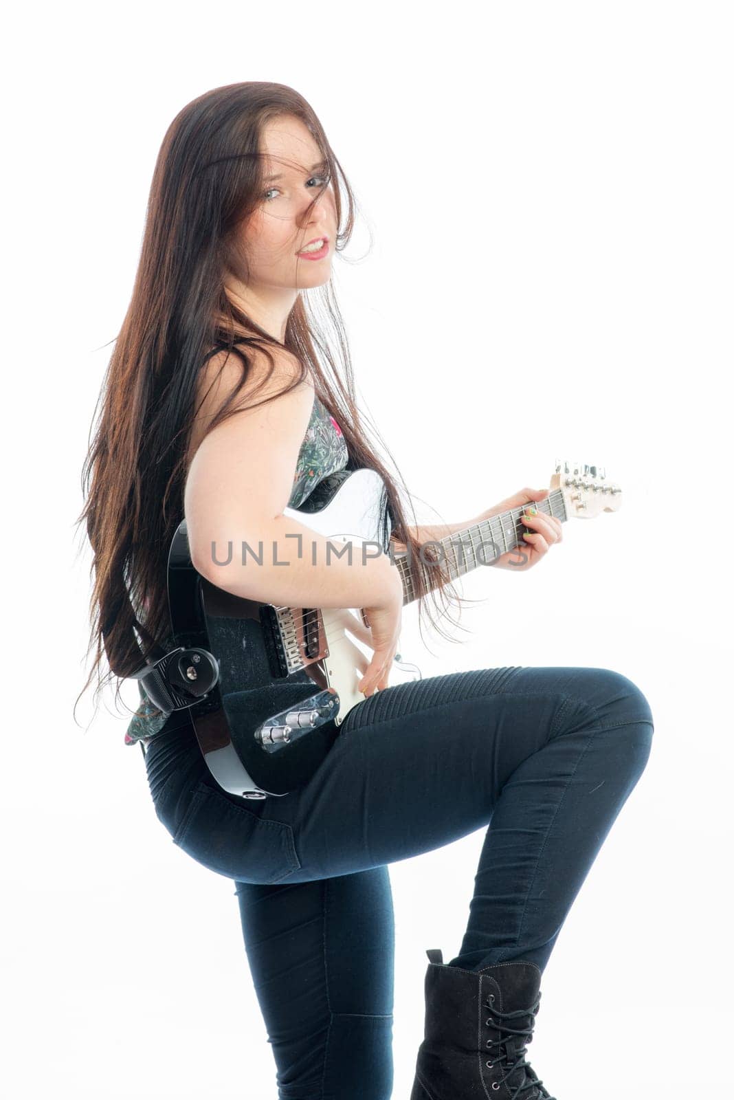 Young woman plays electric guitar