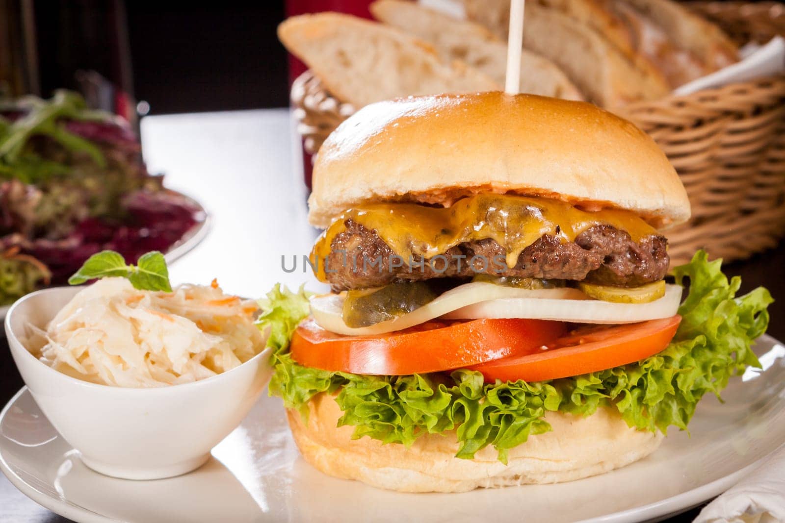 Delicious hamburger cheeseburger with bacon egg and salad on a plate