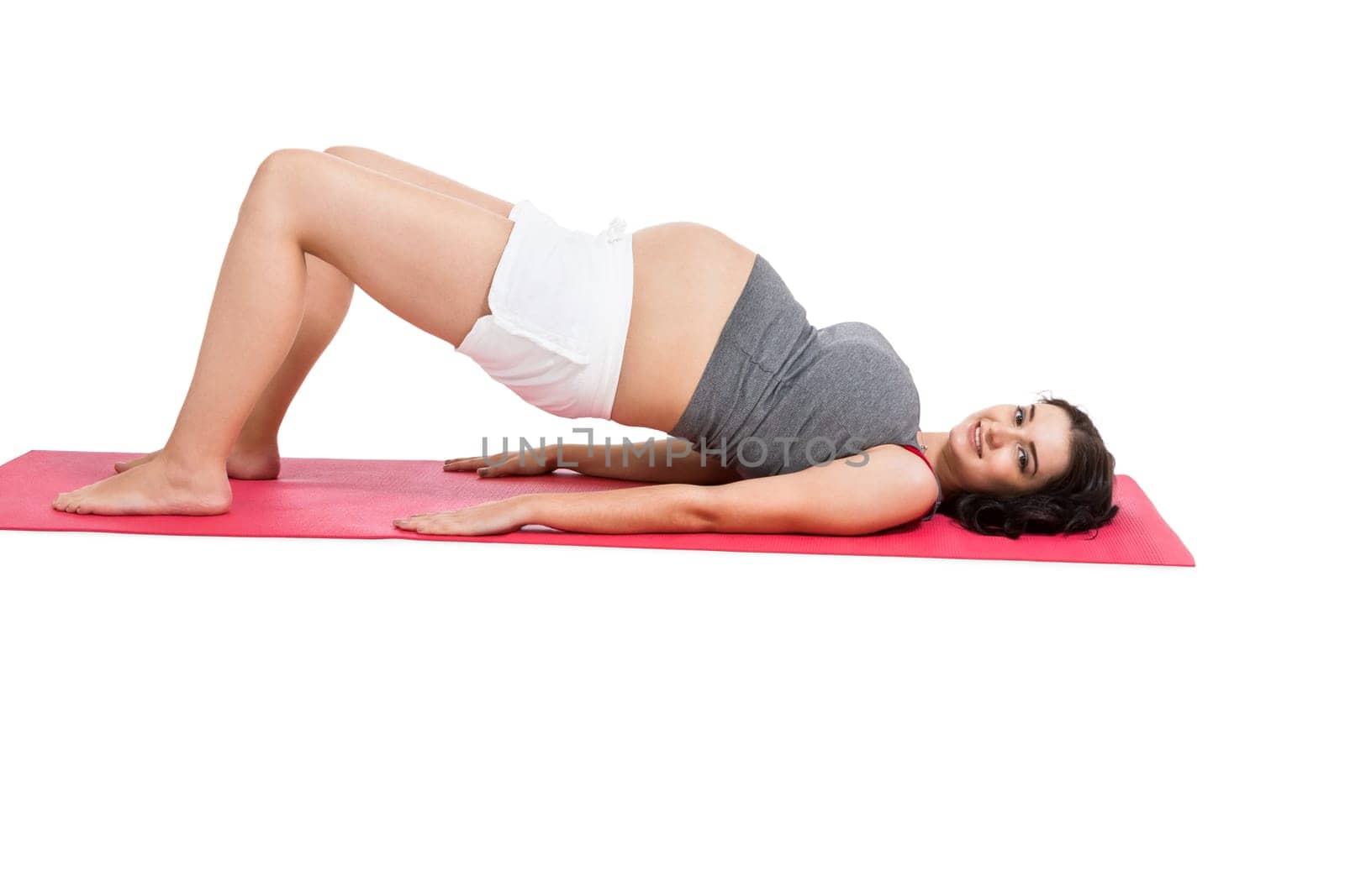 Young woman at birth preparation yoga isolated against white background