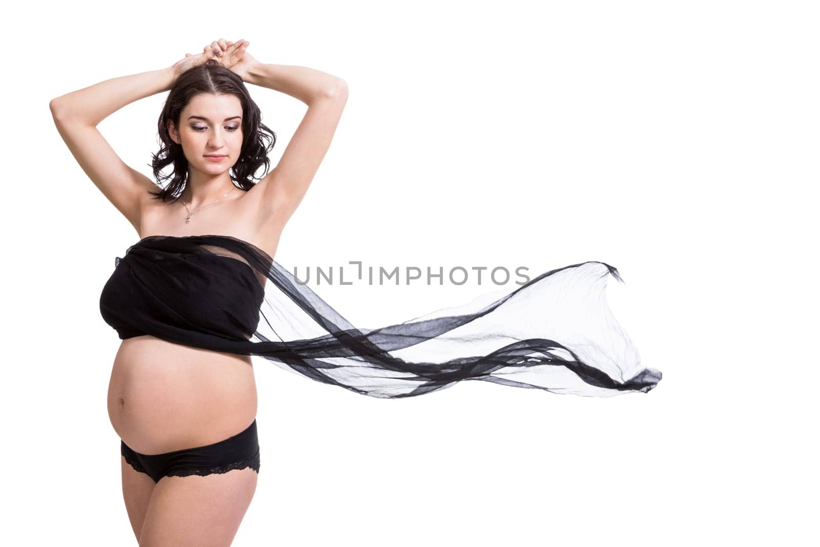 Young attractive pregnant woman wrapped in black fabric insulated against white background