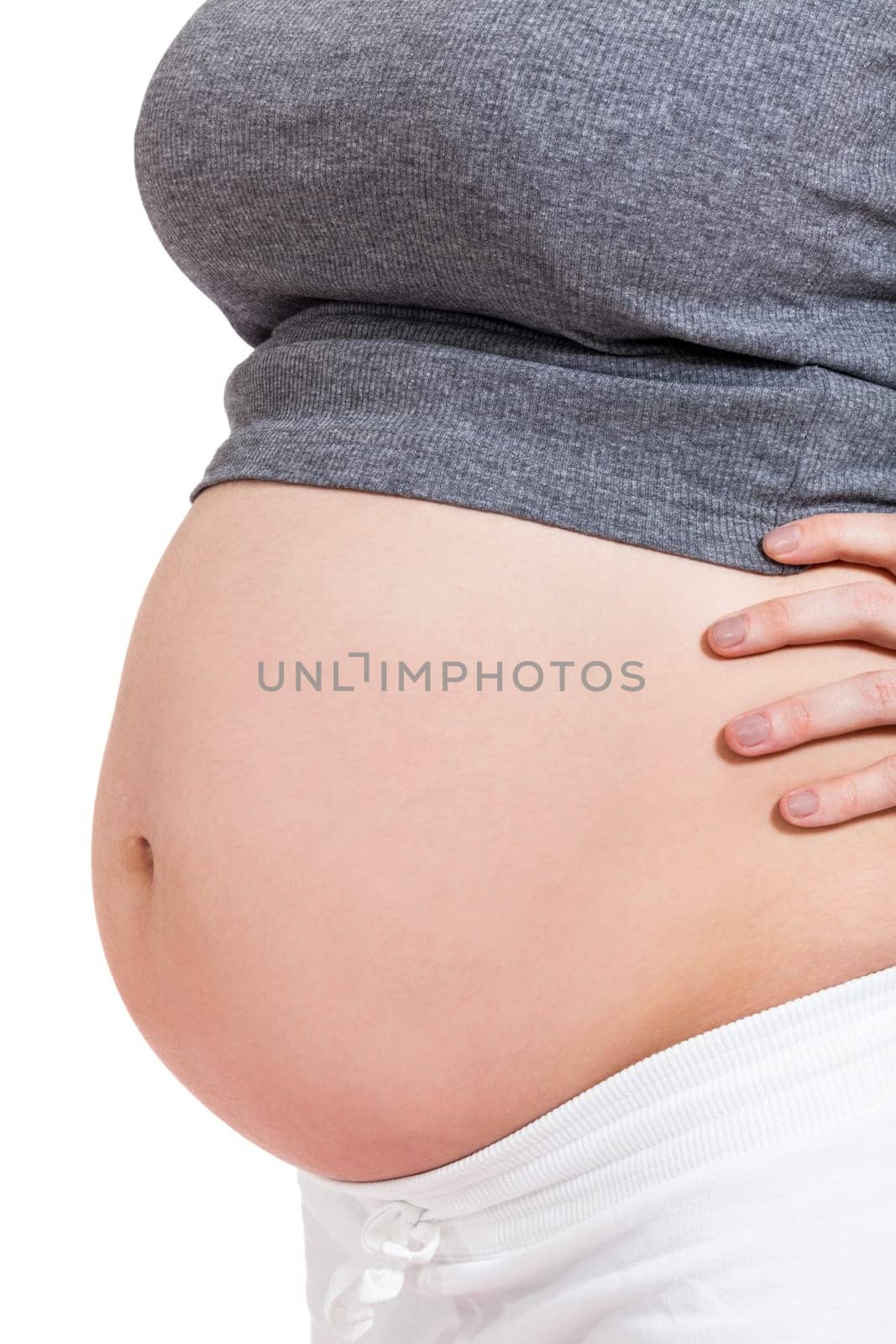 Young woman with baby belly in expectant posture as close-up isolated against white background