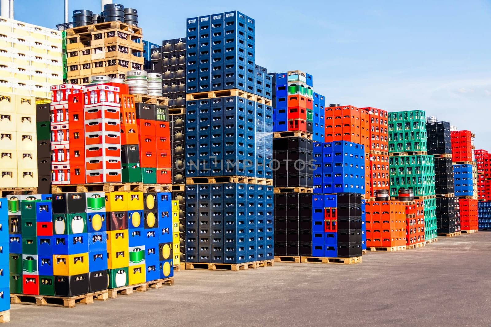 Stacked beverage crates with deposit bottles in an open-air beverage market