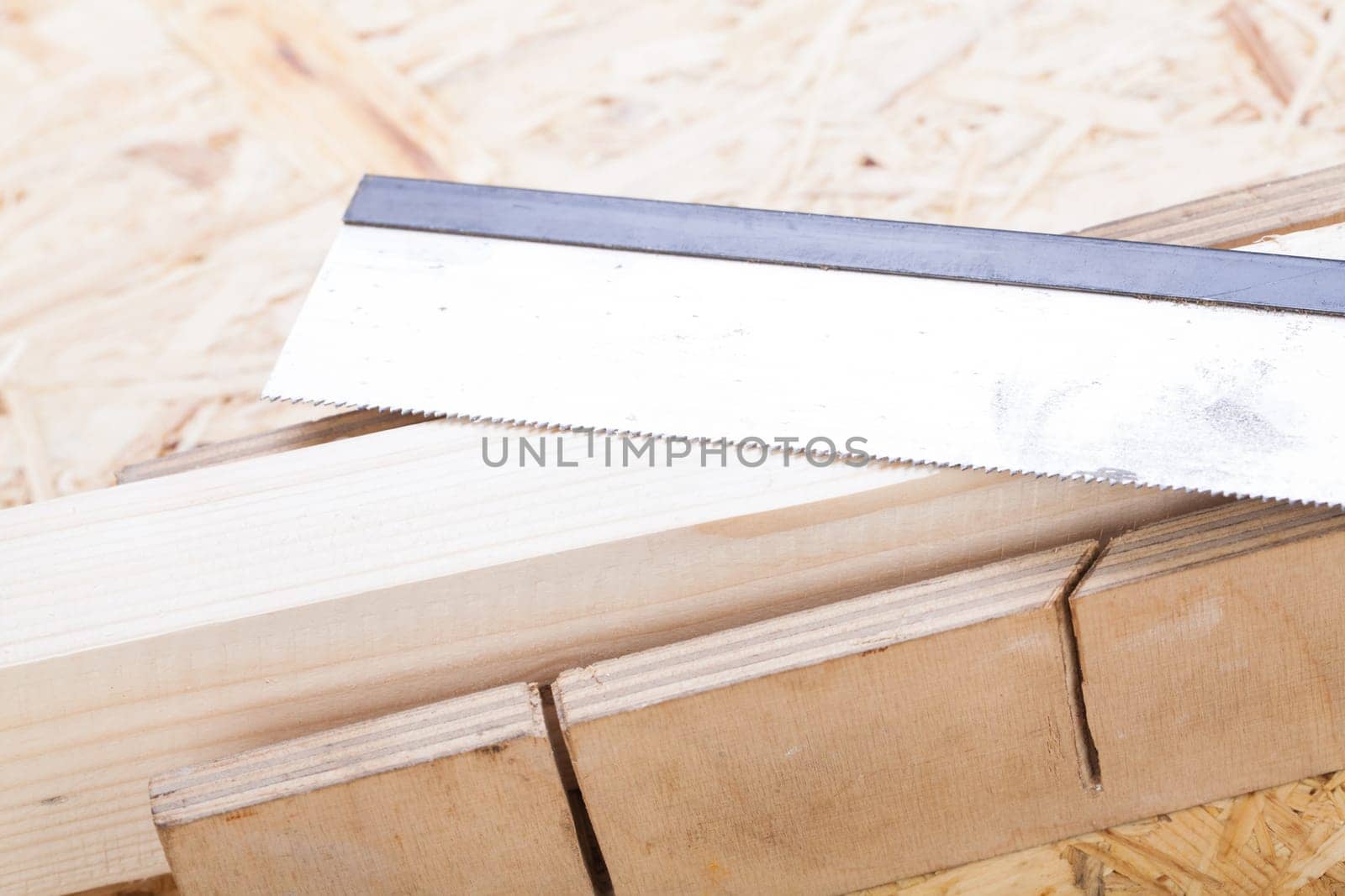 Wood with angle cutter and saw in a workshop close-up detail