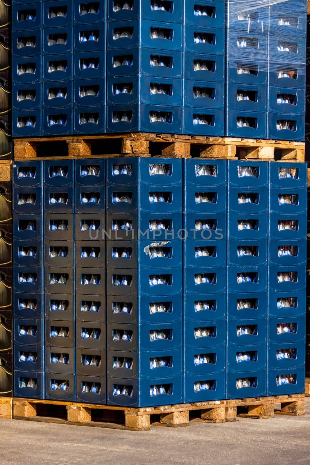 Several stacks of colorful beverage bottle crates outdoors