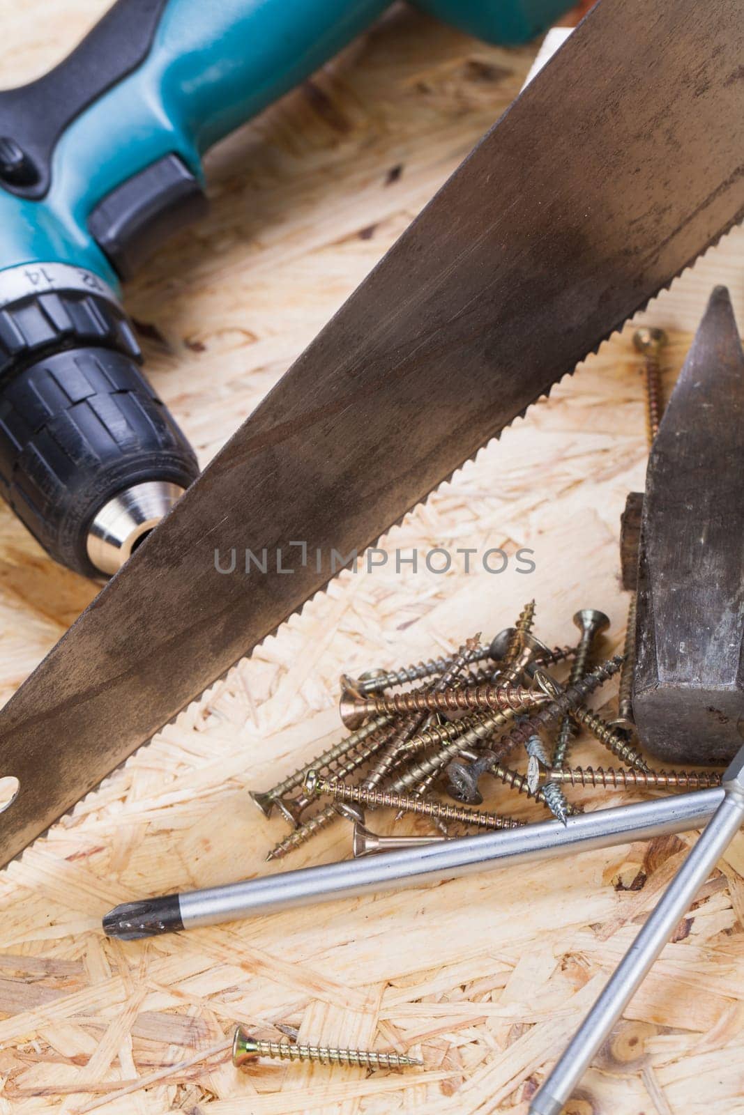 DO-it-yourself tool with cordless screwdriver,screwdriver,saw and screws in a workshop