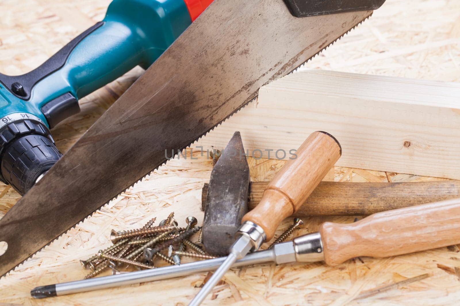 DO-it-yourself tool with cordless screwdriver,screwdriver,saw and screws in a workshop