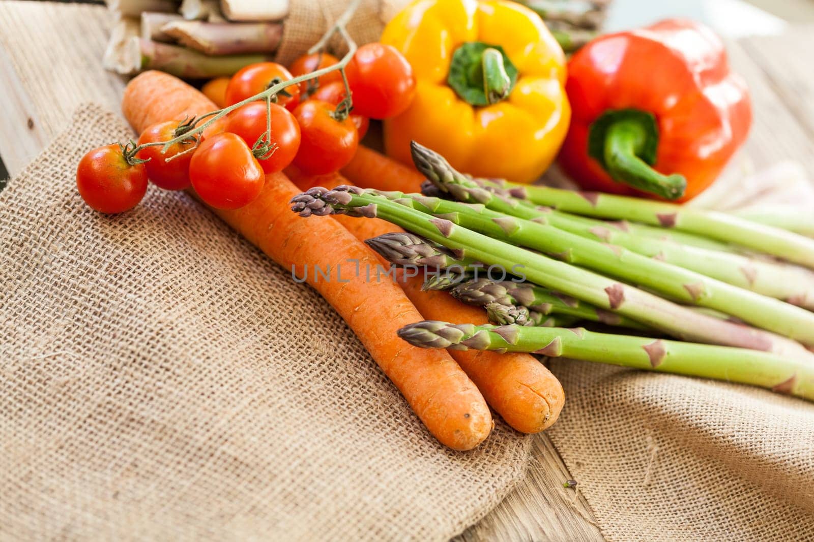 Fresh vegetables with tomatoes,peppers and asparagus as a close-up on an outdoor table