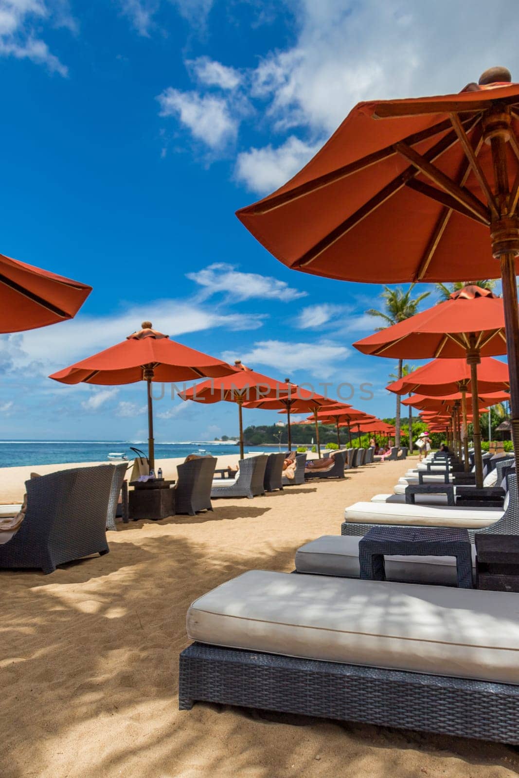 Tropical beach with sun lounger and umbrellas with white sand in the Caribbean