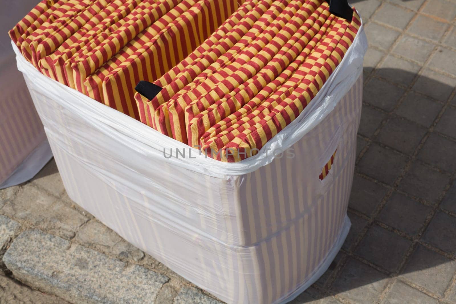 Bag of seat cushion for selling  outdoors bullring. This little cushions are sold  for hard seats of grandstands in Spain bullfighting events