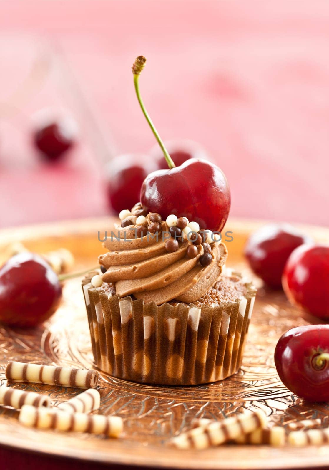 Chocolate cupcake with buttercream and fresh cherries
