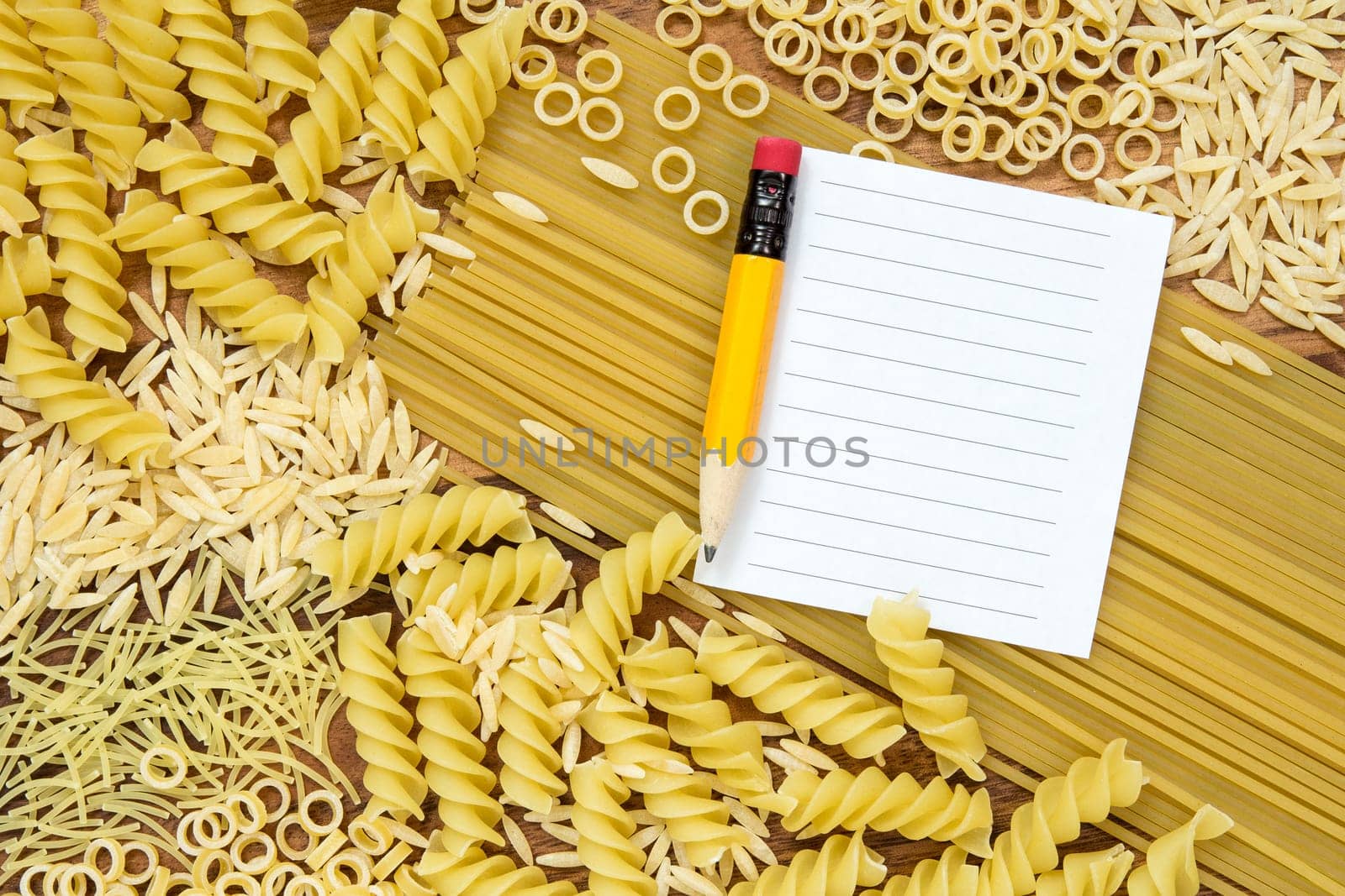Uncooked pasta and blank paper for recipe