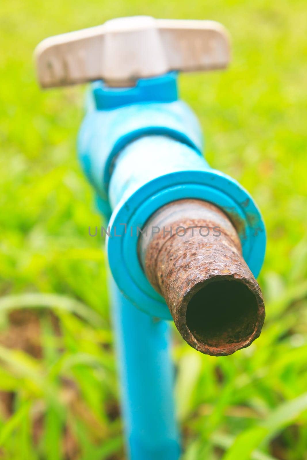old and rusty faucet in a garden