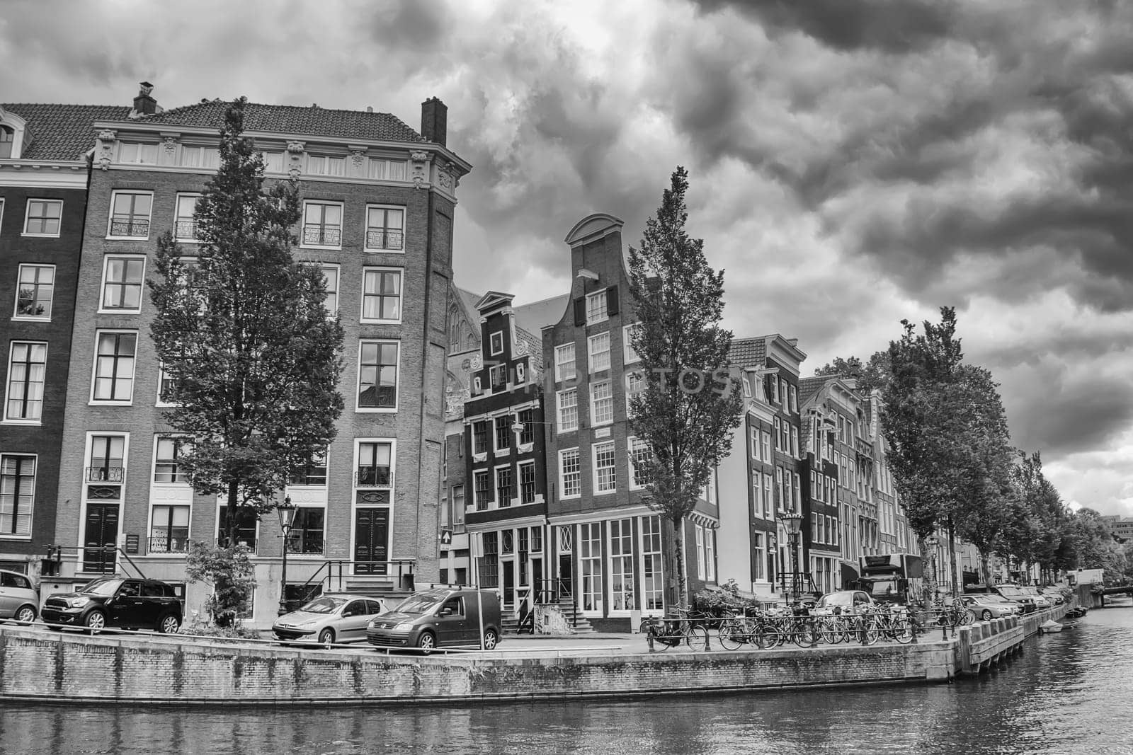 Black and white photo of one of the canals in Amsterdam. (The Netherlands). All potential trademarks are removed.
