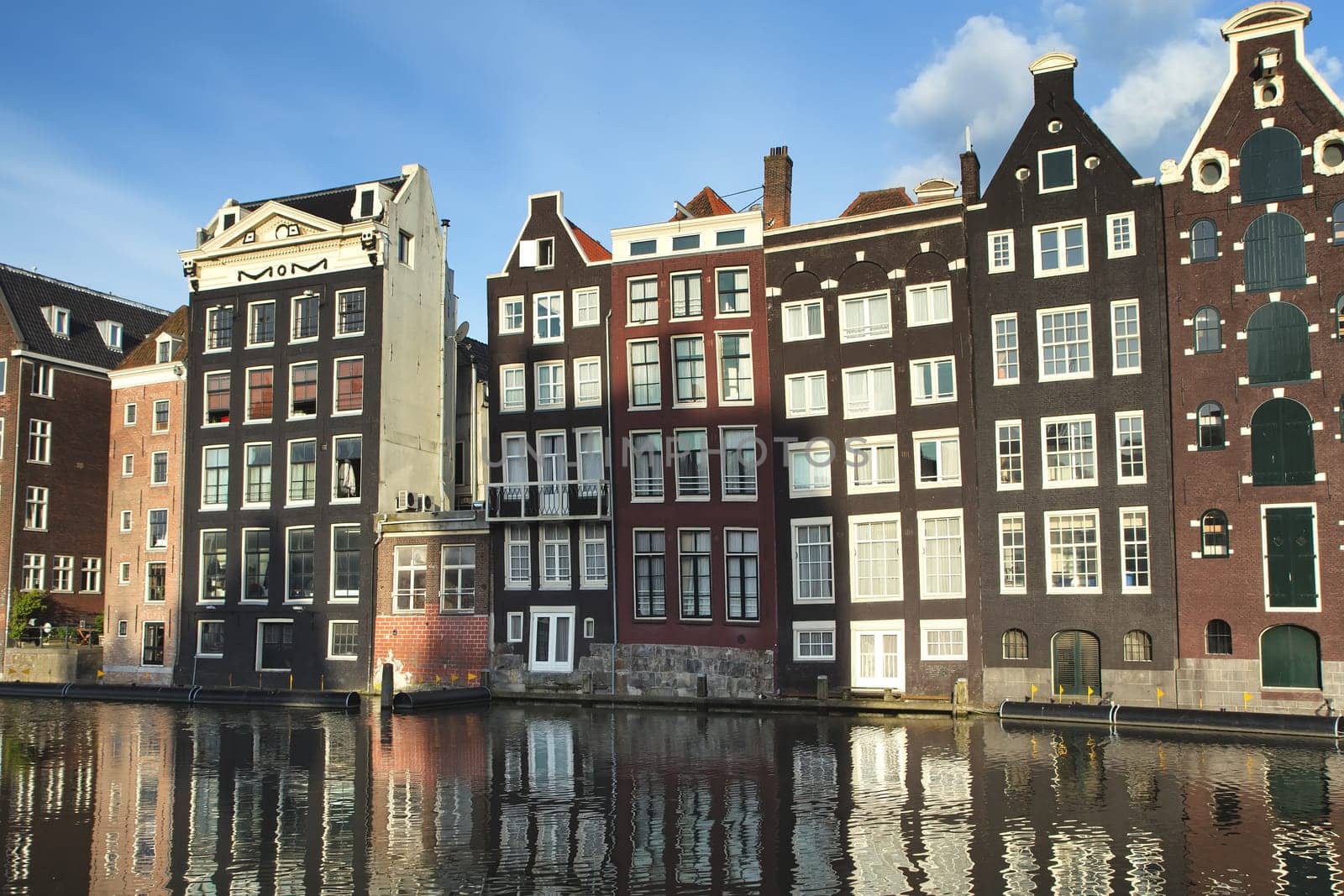 Traditional houses of Amsterdam with canal reflections. (The Netherlands).