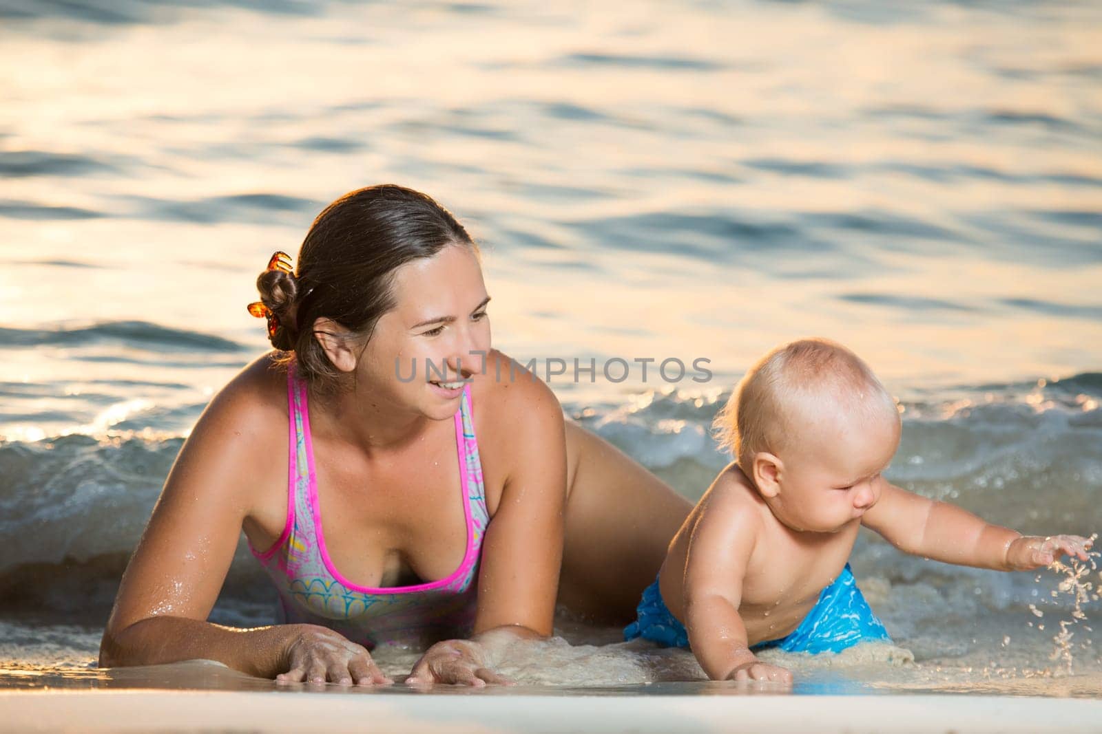 Baby and mother on the tropical beach
