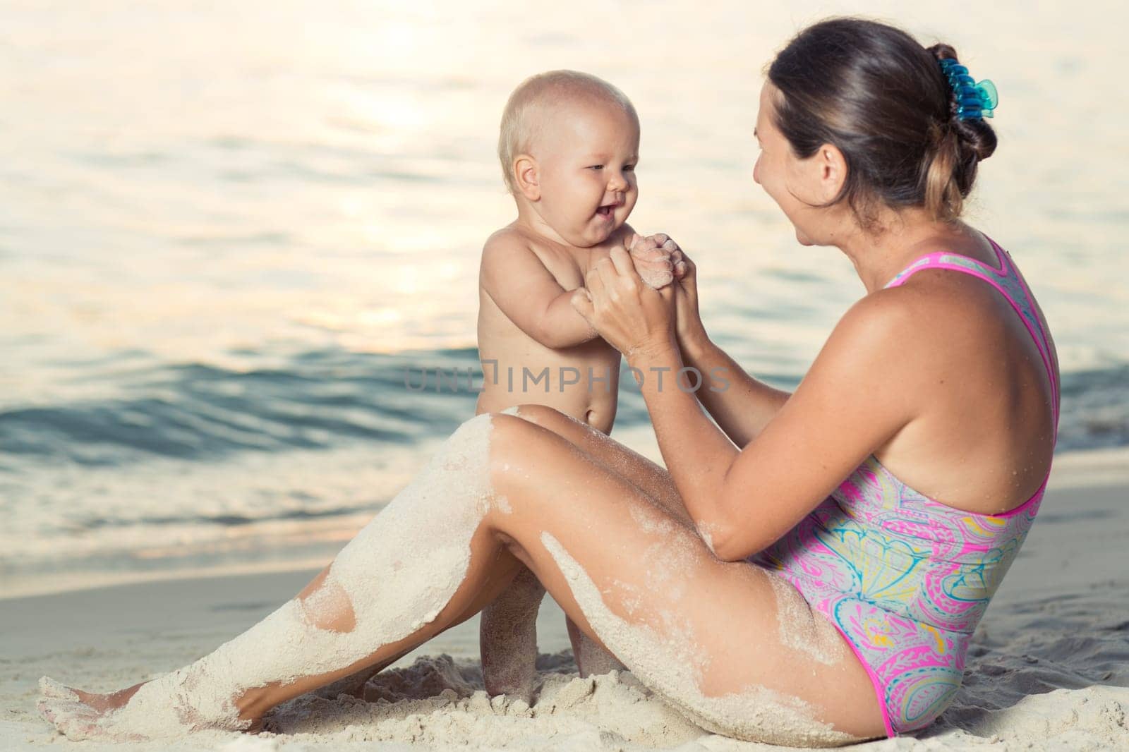 Baby and mother on the tropical beach