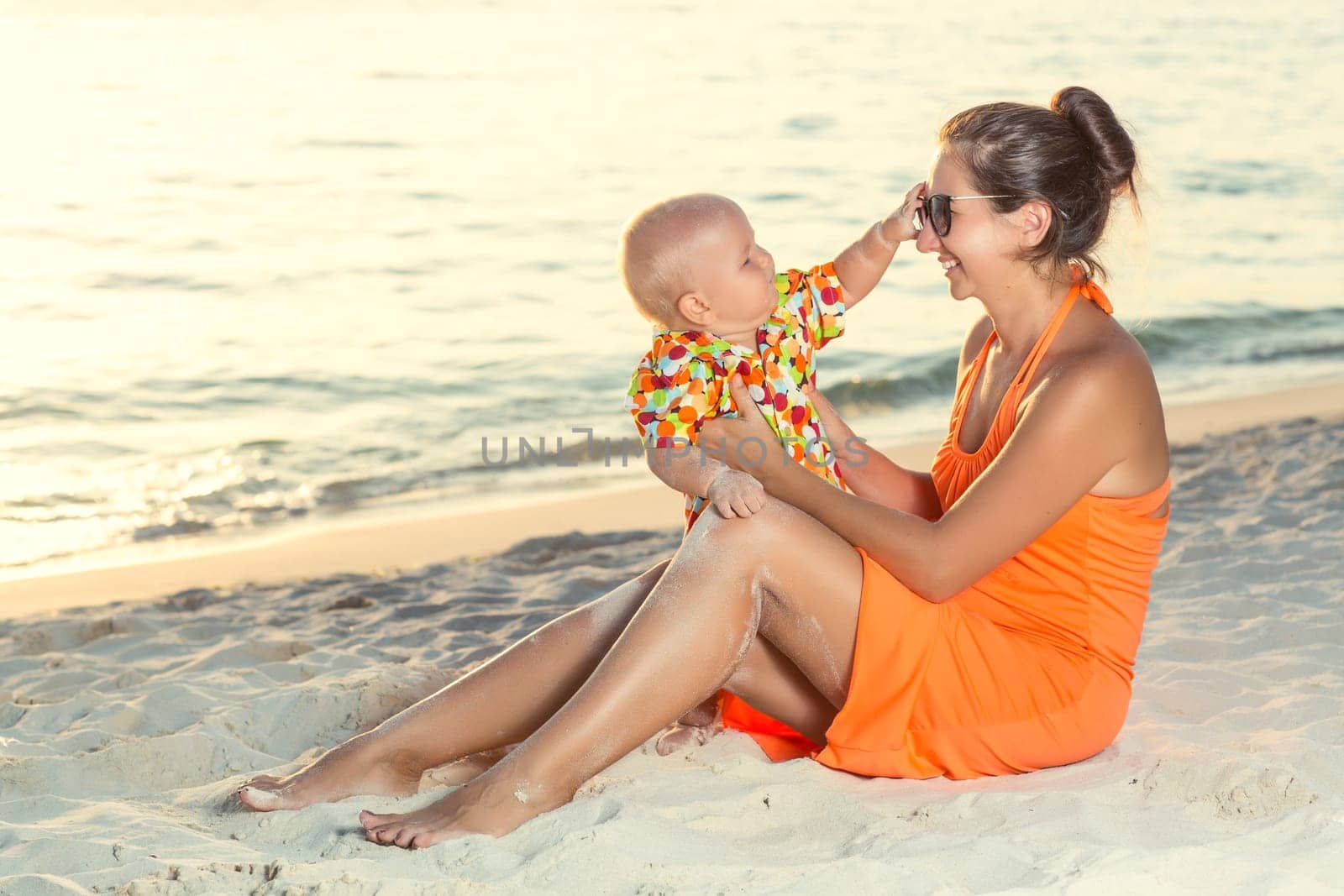 Baby and mother on the tropical beach
