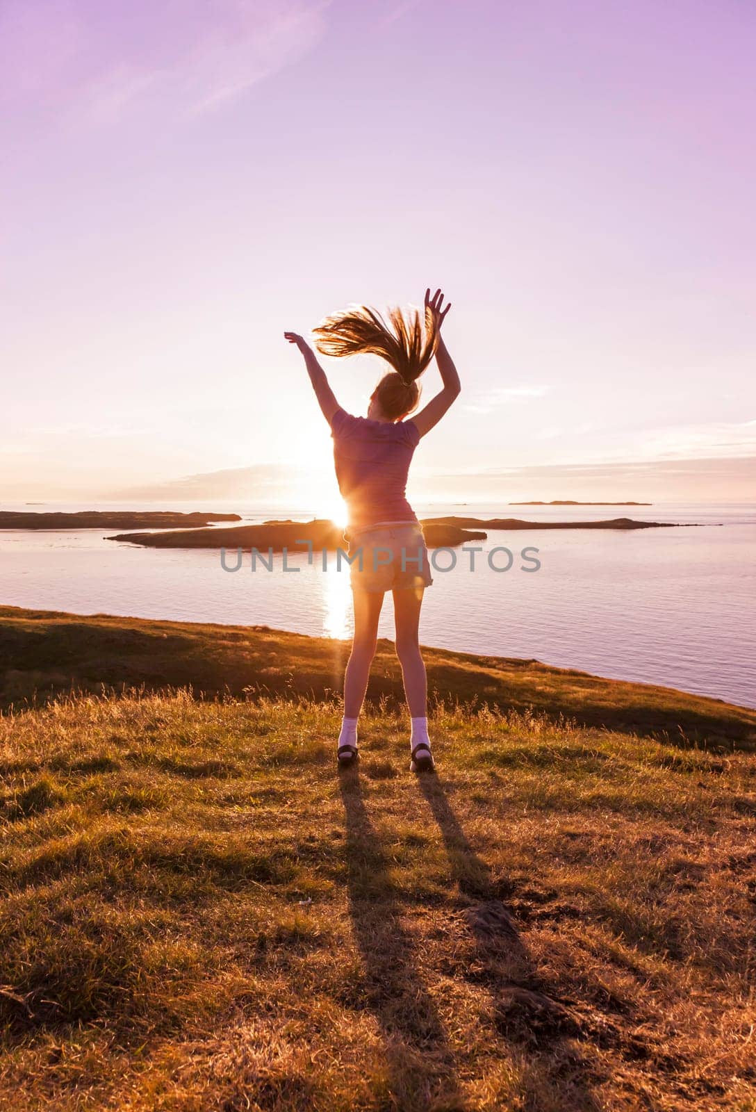 Young girl enjoying life in a beautiful sunset