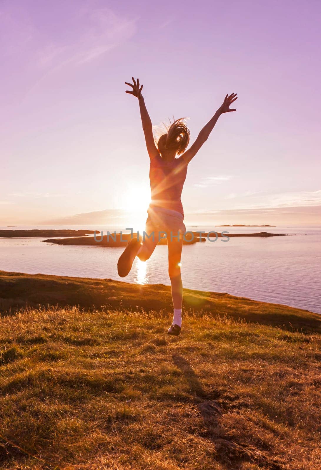 Young girl enjoying life in a beautiful sunset