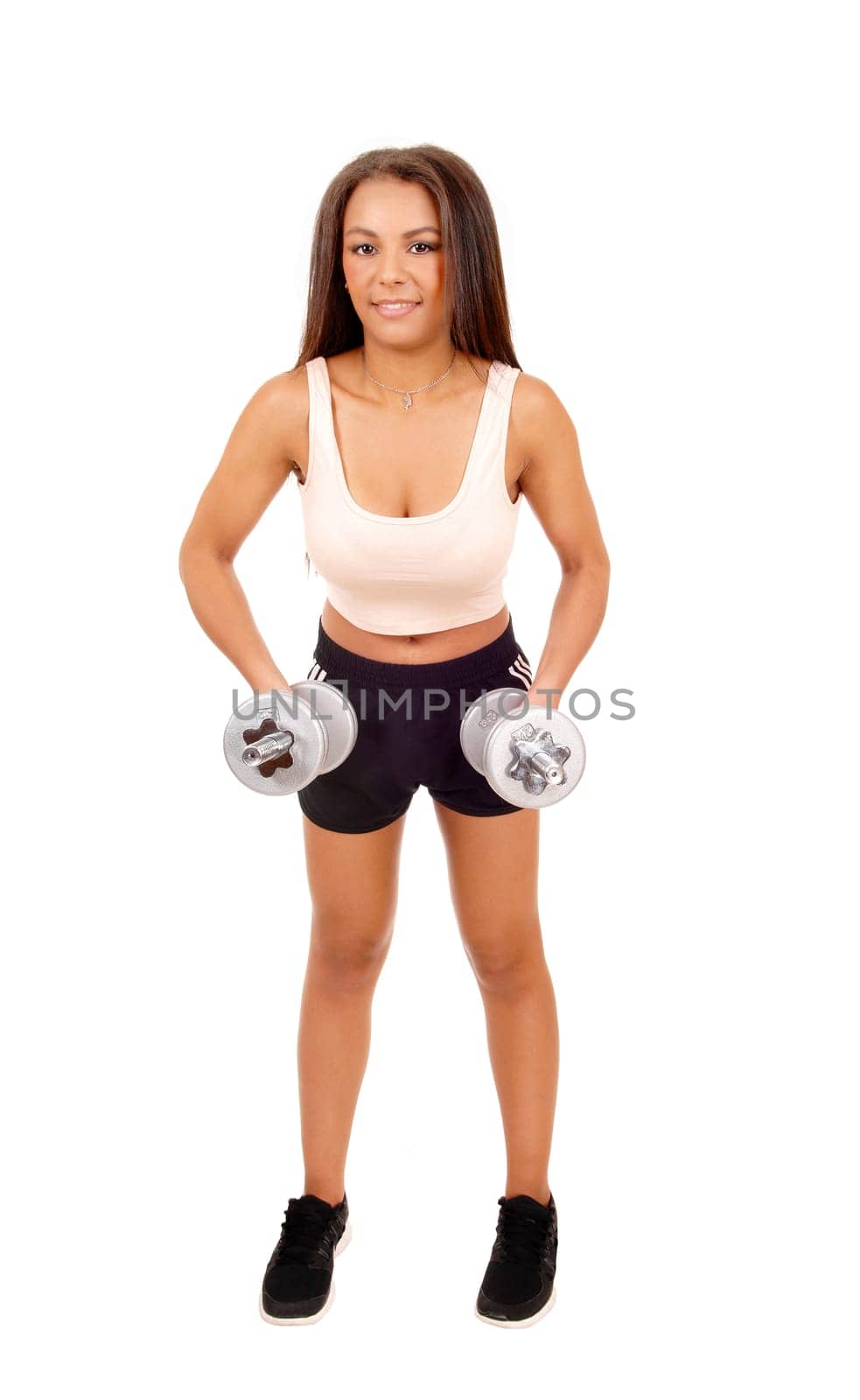 A pretty woman in black shorts standing for white background lifting.two dumbbell's for exercise..