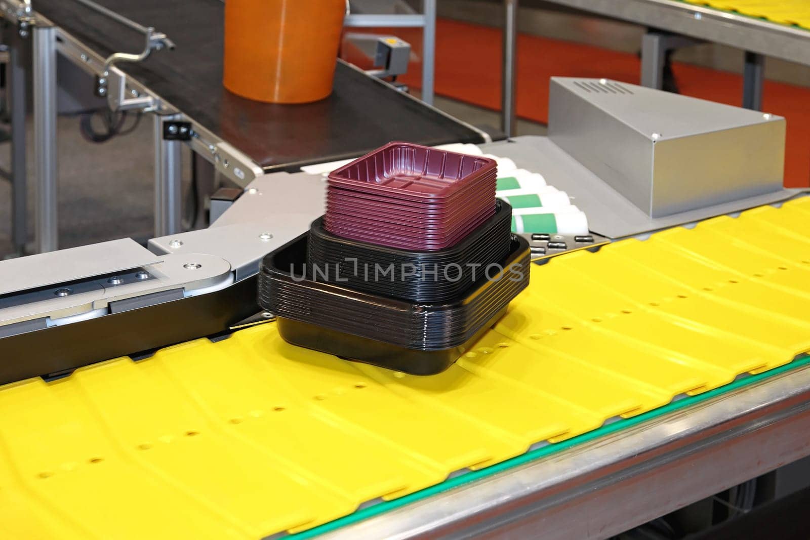 Yellow conveyor belt transport system in factory