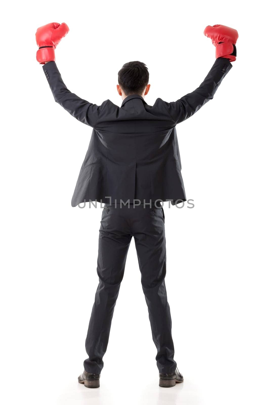Asian businessman with boxing gloves, rear view full length portrait isolated on white background. Concept about fight, struggle, against etc.